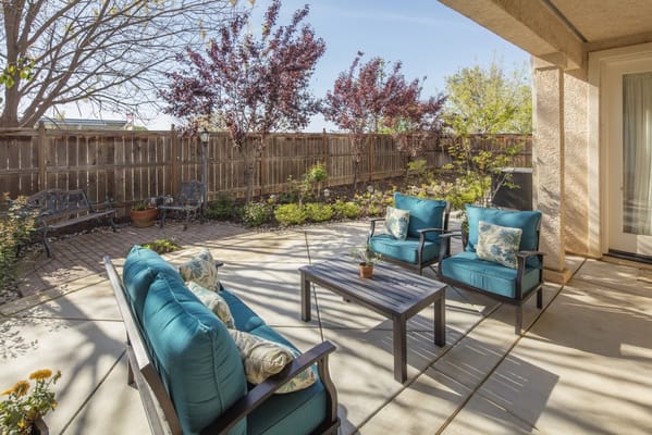 Outdoor seating area with flowers and trees