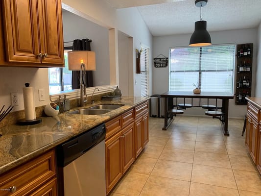 Spacious kitchen with modern cabinets and dining area