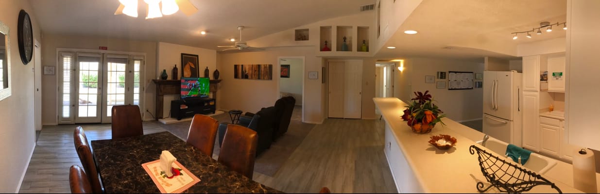 Open living room and kitchen area with dining table and TV