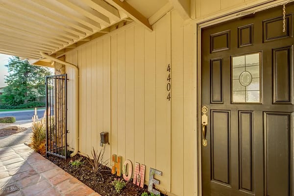 Front door of Aegis at Coconino assisted living facility with decorative 'HOME' letters.