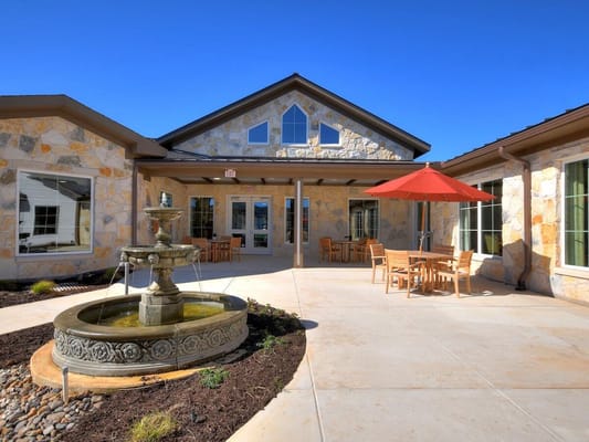 Exterior view of the facility with seating and fountain