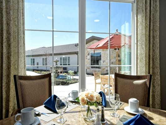 Dining room table with outdoor view and decorative flowers