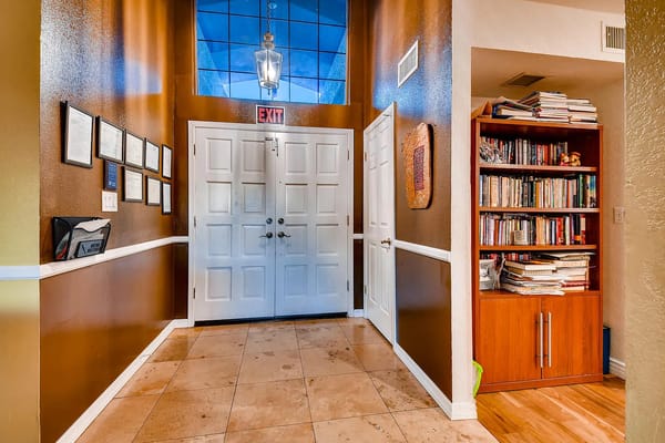 Entrance hallway with doors and bookshelves