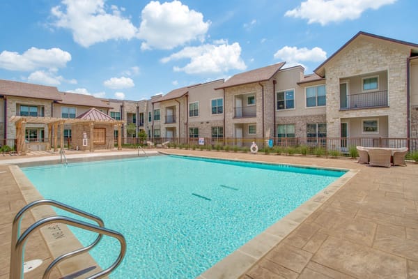 Outdoor pool area with building backdrop