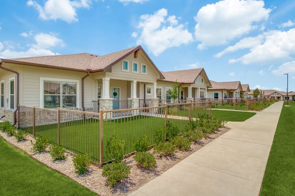 Pathway leading to residential buildings with green lawns