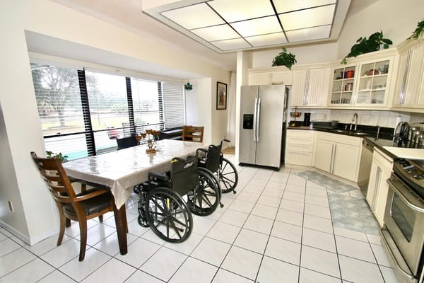 A spacious kitchen area with wheels near the dining table