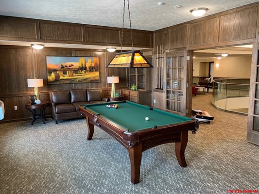 Billiards table in a warmly decorated lounge area
