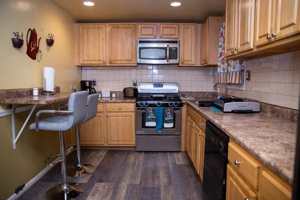 A stylish kitchen with wooden cabinets and modern appliances.