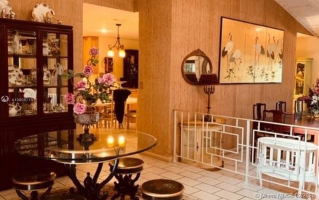 Elegant dining area featuring a glass table and floral decor.