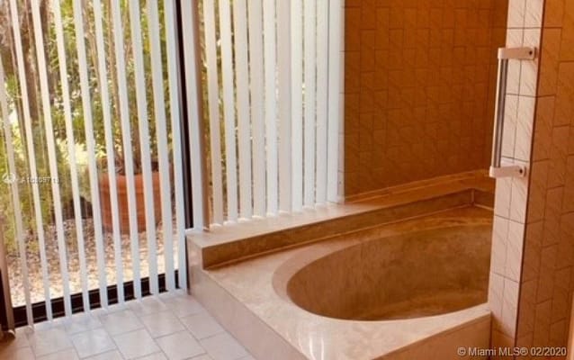Bathroom with a large soaking tub and natural light