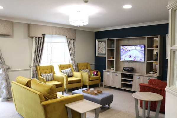 Interior common area with bright seating and a TV