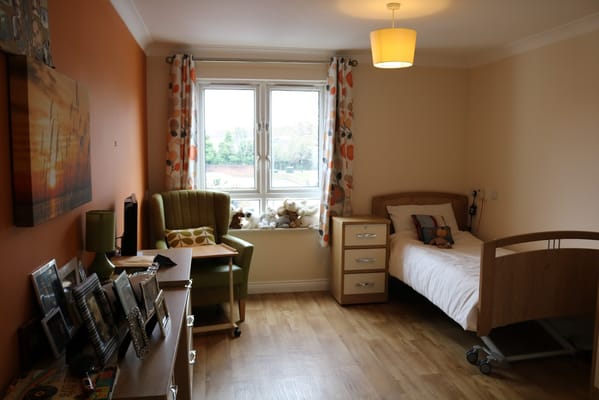 Private resident room with a bed and chair