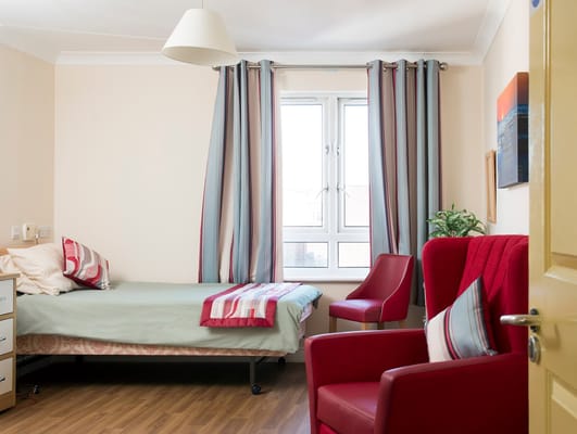 A well-furnished room with a bed and seating area