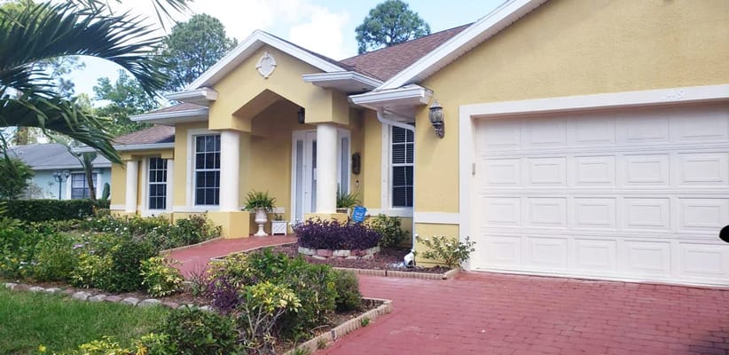 Exterior view of a yellow building with a driveway