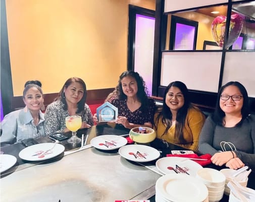 Group of women celebrating in a dining setting