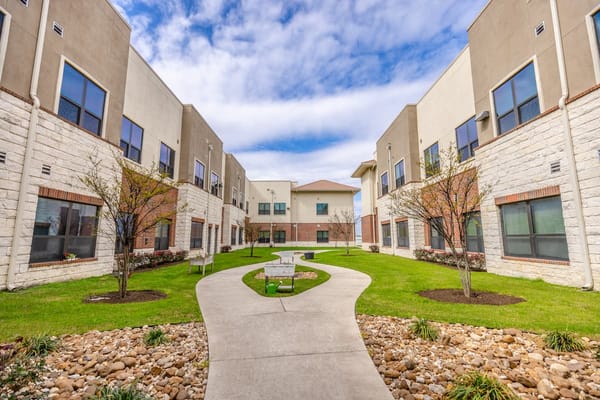 Pathway through a landscaped courtyard at an assisted living facility