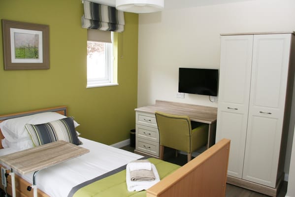 Cozy resident room with bed and desk