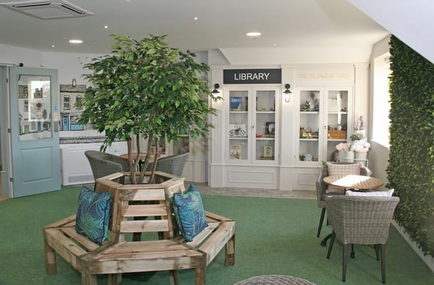 Cozy common area with library display and seating