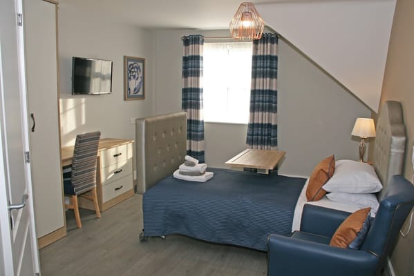 A cozy private resident room with modern furnishings