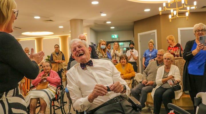 Residents enjoying a celebration in the common area