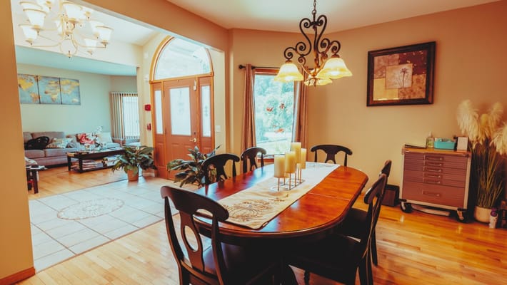 Cozy dining area with wooden table and chandelier