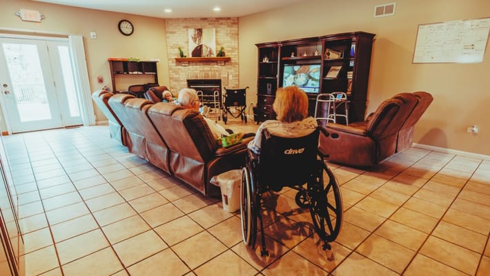 Residents in a common area lounge with comfortable seating