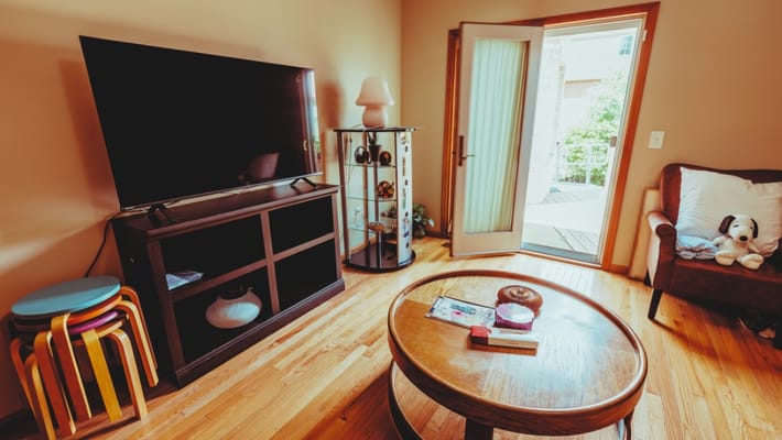 Cozy living room with a TV and a door to the outside