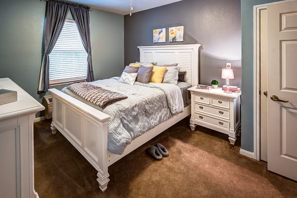 Interior view of a cozy bedroom with a double bed and nightstand.