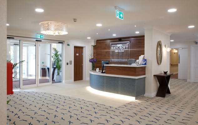 Elegant lobby of a senior care facility with reception.