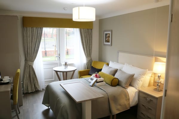 Private resident room with bed and seating area