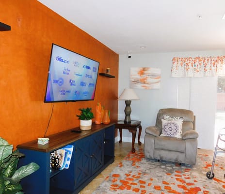 Cozy interior lounge area with an orange accent wall