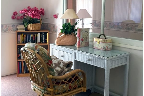 Cozy common area with a chair and bookshelves