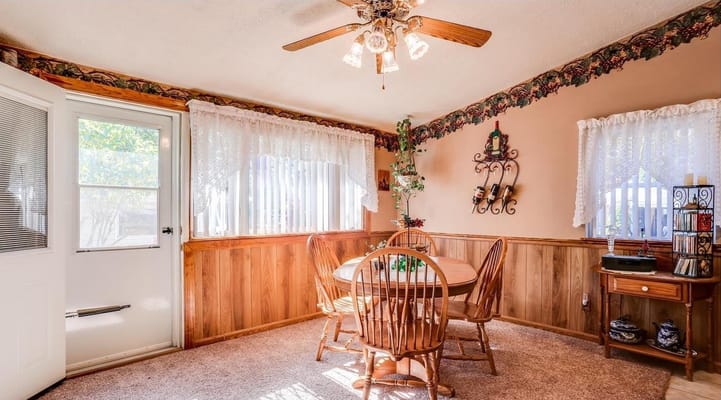 Bright common area with a dining table and windows