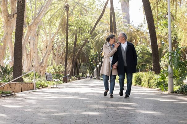 Couple walking hand in hand in a serene outdoor path