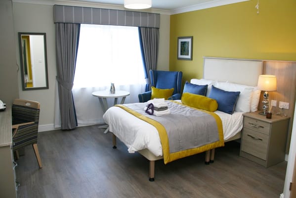 Comfortable resident room with a bed and seating area