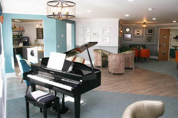 Bright common area with a piano and seating