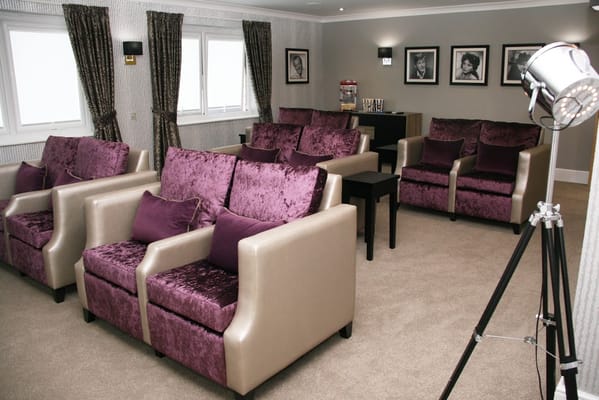 Interior view of a cozy common area with purple couches