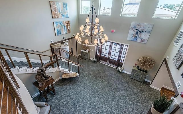 Aerial view of the lobby featuring a chandelier, artwork, and seating area.