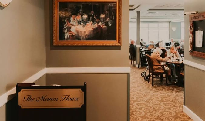 View of dining area in The Manor House with residents enjoying meals