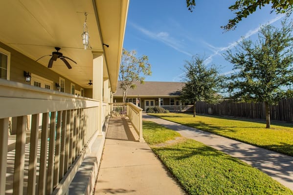 View of a pathway and greenery in a senior living facility
