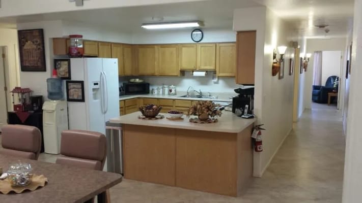 Well-equipped kitchen with wooden cabinets at Mesa Elder Care