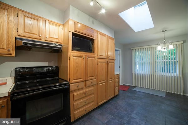 Spacious kitchen with wooden cabinets and modern appliances