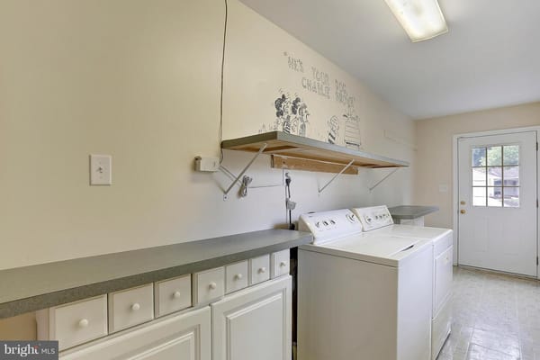 Laundry room with washing machines and countertop
