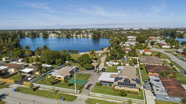 A scenic aerial view of a lake surrounded by residential areas.