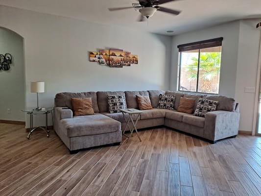 A cozy living room with a sectional sofa, decorative pillows, and a coffee table.