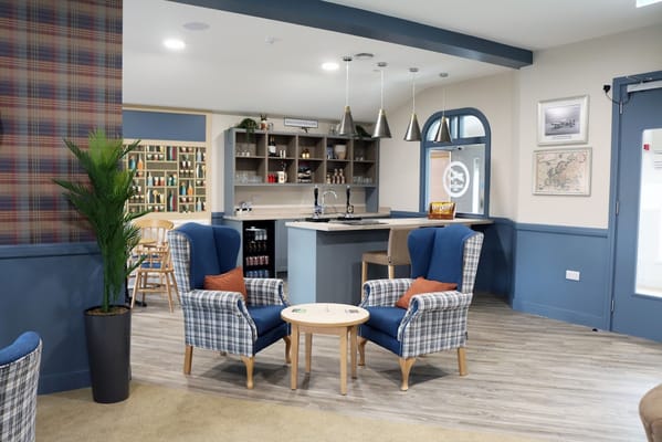 Cozy lounge with two blue armchairs and a coffee table