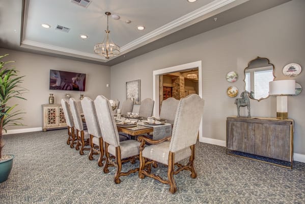 Spacious dining area with a long table and elegant chairs