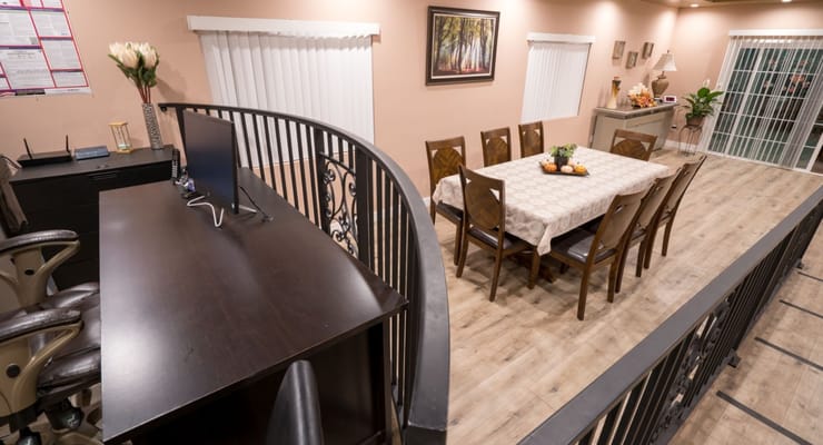 Overview of the dining area with a table and chairs