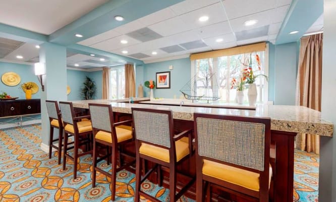 View of the bar area with high stools and decorative accents.