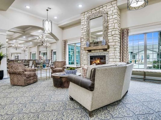 Bright common area with seating and fireplace